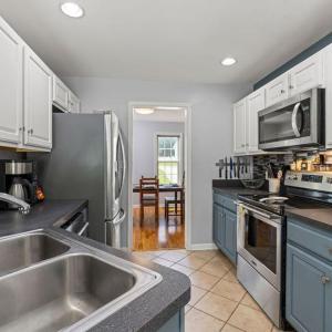 The kitchen is compact and has lots of cabinets and counter space.