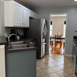 Double kitchen sink is on an angle with workspace between it and the refrigerator. All appliances convey.