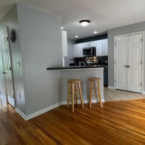 The kitchen island. The 1/2 bath door is the first door on the R on the hallway. The next door on the R is the coat closet. Opposite the bathrooom door is the door to the finished basement.