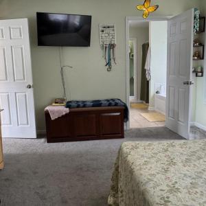 The lovely Primary bedroom is spacious. The door to the bathroom is shown here also.