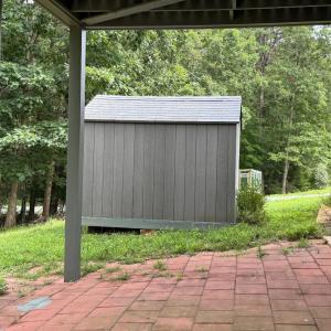 A view of the patio and also a fenced garden spot beyond the shed. Both sheds convey.
