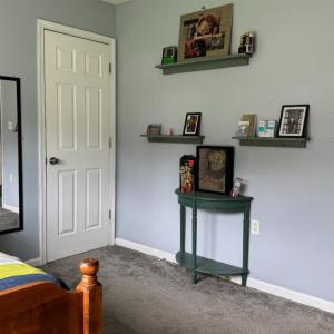 It also has a large closet and shelves on the opposite wall to this closet.