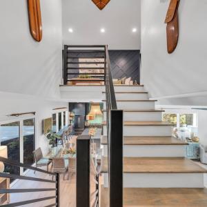 Enter the upper level loft/living room, full bath and 2 additional bedrooms each with access to the upper covered deck overlooking the lake!