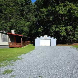 the two car enclosed carport is at the top of the driveway.