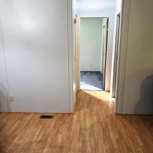 Hallway to the remaining two bedrooms and full bath