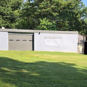 30x30 workshop with new sealed roof, garage door for equipment storage or repair.