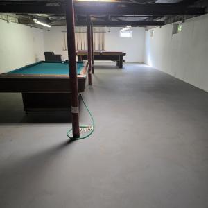 The full basement served as a "private pool hall" The tables can stay or be taken away at the new owners request.