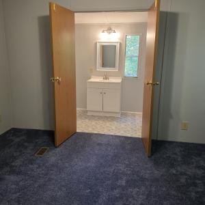 double doors to the ensuite primary bathroom