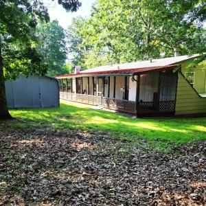 A nice view from the wooded lot next door. ( two separate parcels were combined to make one) The 8 acre parcel could easily be separated into two parcels
