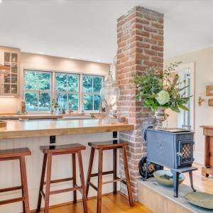 Cozy up with your morning coffee next to the Jøtul “Little Giant” wood stove with glass door.