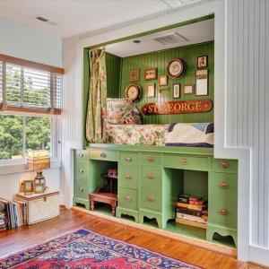 “Jefferson-style” curtained bunk sits atop two student desks taken from UVA Lawn.  Hidden storage underneath bed contains 8 boxes of all Christmas ornaments and other holiday accoutrements.  Storage area also contains back panel access to Grecian tub in bathroom.