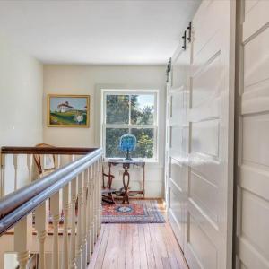 Doors taken down from reconstruction retrofitted as sliding doors to frame new upstairs closet with heavy-duty utility shelving.