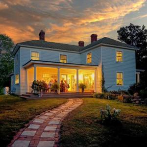 Sunset Dinner Party - The westward-facing side porch sets the stage for golden-hour dinner parties, with comfortable seating up to 14 guest.