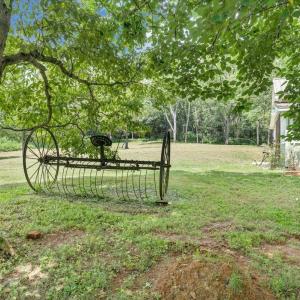 Hay rake found during restoration submerged on property and placed under Dogwood tree!