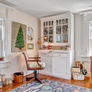 Three original fireplace mantels were retrofitted to frame the bedroom windows, complimenting the furniture original to the house. Bespoke window shades adorned with elegant passementerie trim.