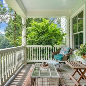 Front porch/veranda with some original furniture (including chicken coop table). “New” railings from Lynchburg mansion, completely restored.