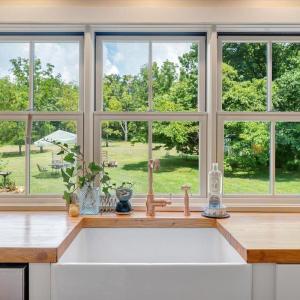 All windows in Kitchen and Bathrooms set directly on countertops. Countertops are 3” thick 1940’s vintage bowling alley from Richmond.  Setting pins marks inlaid cherry.