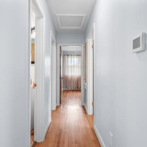Hallway from living room and kitchen towards bedrooms and bathroom
