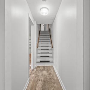 Basement hallway view looking towards the stairs going up.