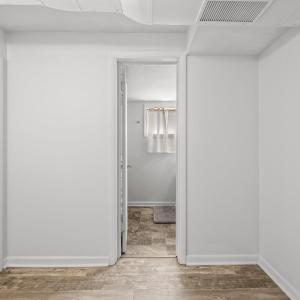 Basement hallway view looking towards bathroom and bedroom