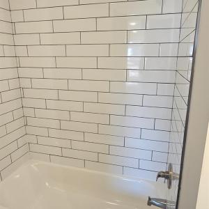 Full hall bath w/ ceramic tile shower walls, tub & granite topped vanity
