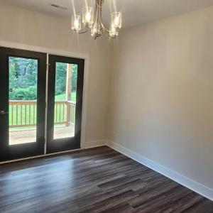 Formal DR open to kitchen, French doors lead to large covered deck which overlooks  greenspace in the rear yard