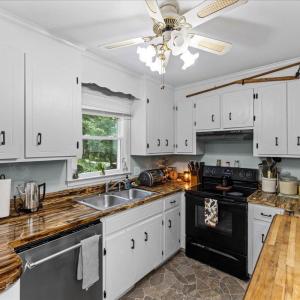 Love the huge window overlooking the pretty back yard and trees. There are 8 brand new windows in the home!