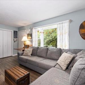 spacious living room off the front door with a wide bow window