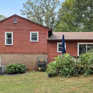 The back of the house! Mature plantings, trees for shade. The new heat pump!