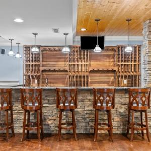 Gorgeous stone bar area that seats 8.  All custom-made wine racks with sink and ice maker