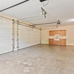 Oversized three car garage with sink and cabinet area