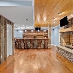 Beautiful stone gas fireplace with logs and tongue and groove ceiling