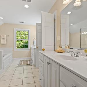 Primary Bathroom separate sinks.  New seamless glass shower and soaking tub