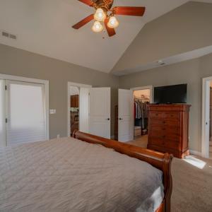 Prinary bedroom looking into pri,ary bath to right and walkin closet to left, door to deck far left