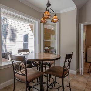 Breakfast area overlooks rear yard, hallway to laundry room & half bath