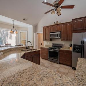 Kitchen showing granite counters & breakfast bar & breakfast area at bay window
