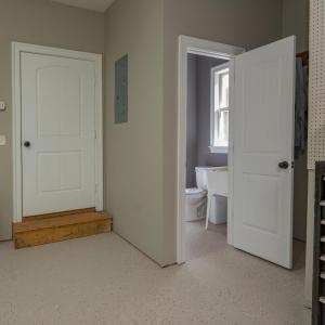 Garage showing half bath to right  , door to left goes through covered walkway to house
