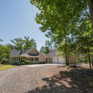 Circular driveway is gravel but has a concrete parking area at house
