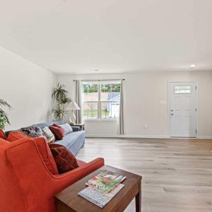 Looking toward the front door. There is a closet under the stairs which houses a full house water filtration system.