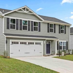concrete paved driveway and 2 car garage