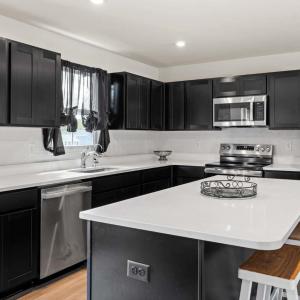AWESOME KITCHEN with beautiful espresso colored cabinets and granite counters. All appliances convey