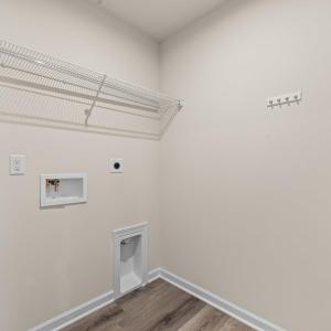 The 6'5"x5'4" laundry room is in the middle of the upstairs hallway between bedrooms 2 and 3