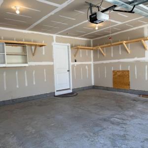 Shelves on the back wall and right wall, door to downstairs hallway. The square here is access to the full house water filtration system