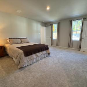 Two windows on the front of the house. The door on the right is the bathroom