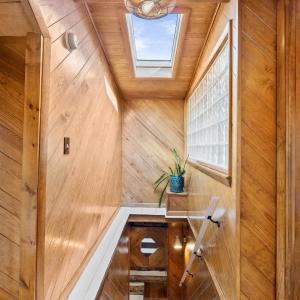 Stairway to Upper Level Featuring Sky Light & Glass Brick Wall