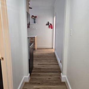 View from the back of the hallway that leads to the second bath, third bedroom, and  laundry area