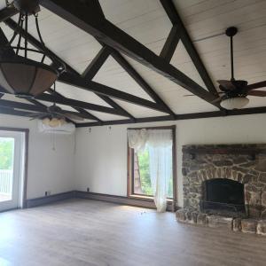 Vaulted ceiling and fireplace in primary bedroom