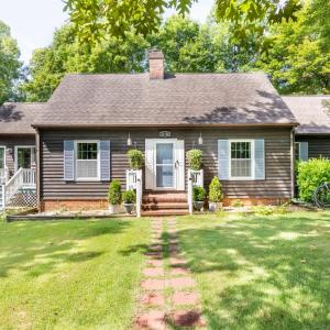 This front view of 11766 Five Forks Road shows front entrance at center, sun room entrance on left and attached garage on the right.