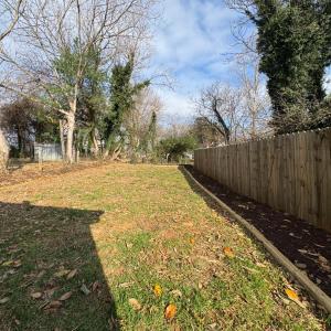 Deep back yard with privacy fence with a sunny garden space ready to plant in!
