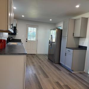The really nice kitchen! Door leads to the back yard (and storage room)